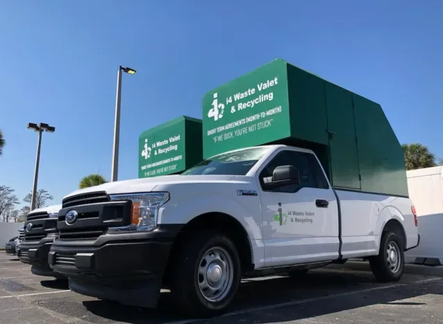 i4 Waste Valet branded green fleet trucks in Orlando, Florida